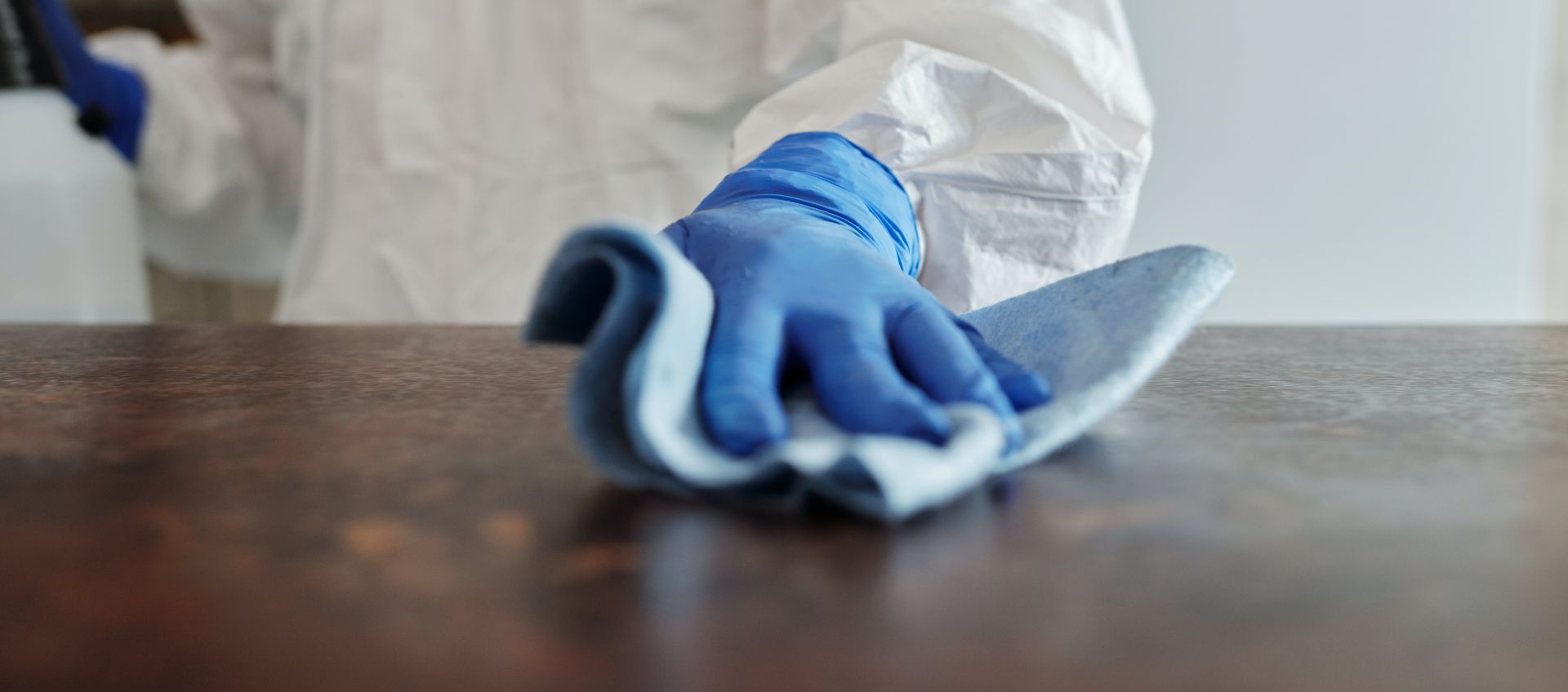 Close-Up Photo Of Person Cleaning The Table